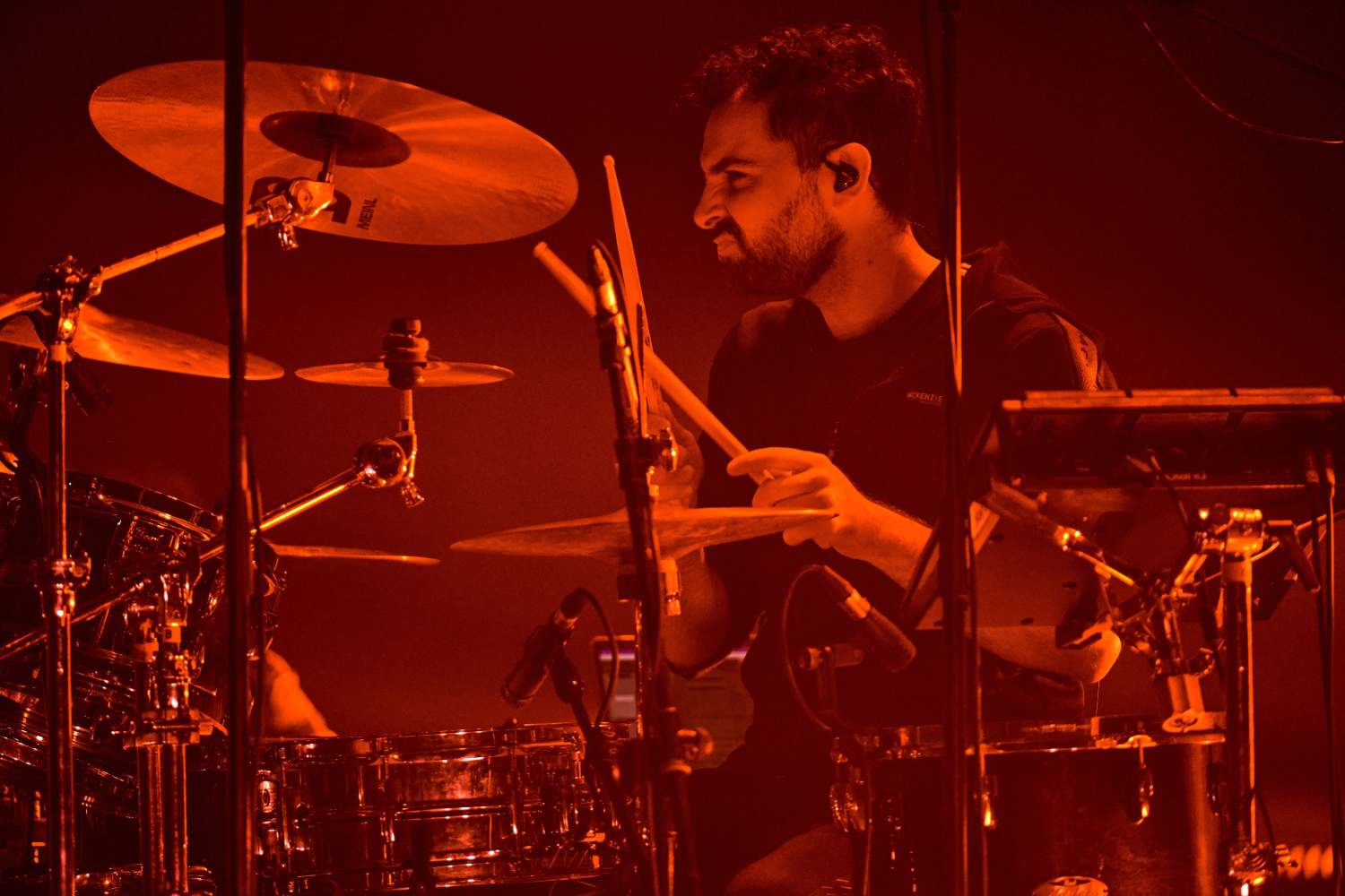 Miguel Lamas behind the kit wearing the DREAM custom in-ear monitors